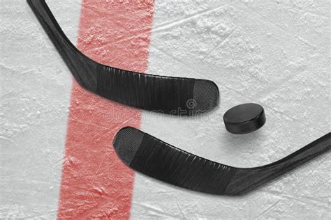 Ice hockey stick and puck