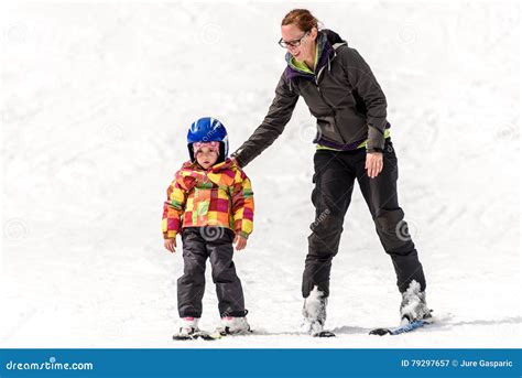 Ski instructor teaching a child